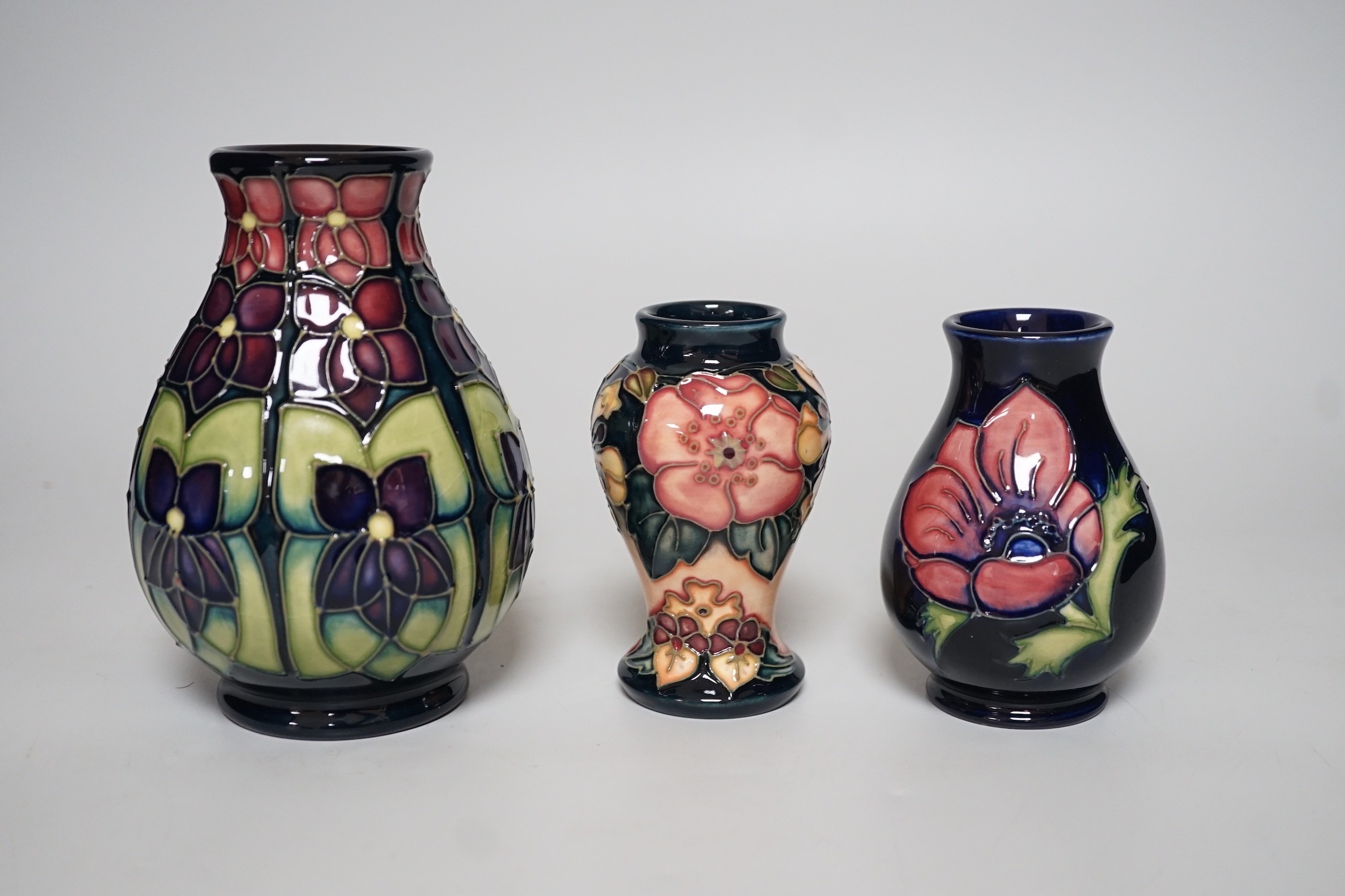 Three boxed Moorcroft vases of varying shapes, tallest 14cms high